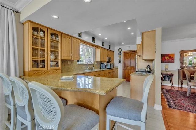 1506 Ameluxen Ave, Hacienda Heights, CA 91745 - kitchen featuring a sink, glass insert cabinets, a peninsula, light stone countertops, and recessed lighting