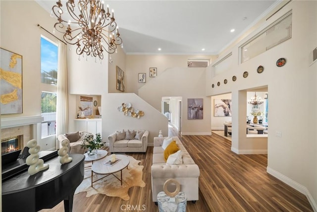 15 Pebble Bch, Coto De Caza, CA 92679 - living room with a chandelier, a towering ceiling, crown molding, wood finished floors, and baseboards