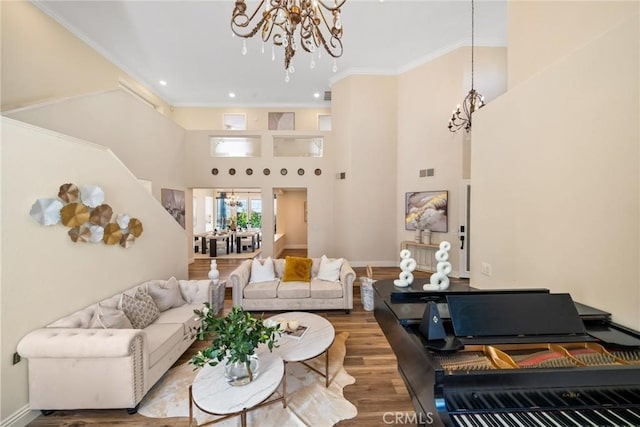 15 Pebble Bch, Coto De Caza, CA 92679 - living room with a chandelier, wood finished floors, crown molding, baseboards, and a towering ceiling
