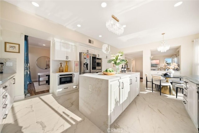 15 Pebble Bch, Coto De Caza, CA 92679 - kitchen with a chandelier, recessed lighting, light marble finish flooring, white cabinetry, and a center island