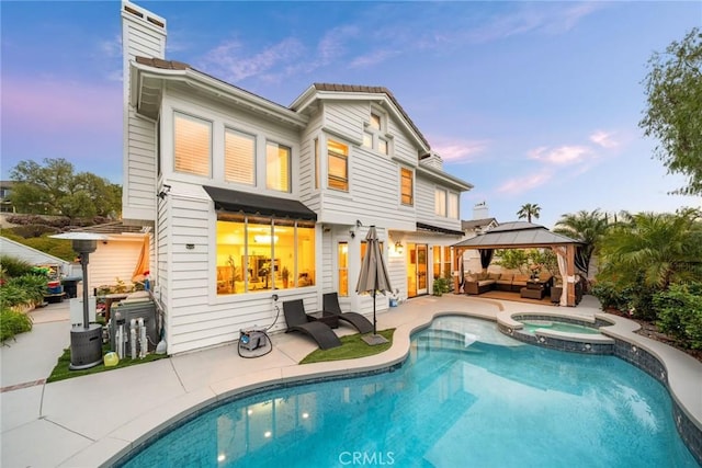 15 Pebble Bch, Coto De Caza, CA 92679 - back of house with an outdoor hangout area, a gazebo, a patio area, a chimney, and a pool with connected hot tub
