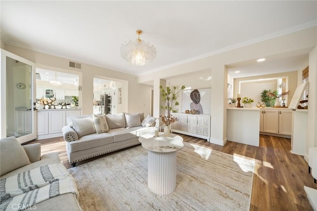 15 Pebble Bch, Coto De Caza, CA 92679 - living area featuring a chandelier, wood finished floors, and crown molding
