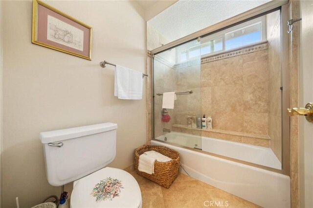 full bath featuring enclosed tub / shower combo and toilet