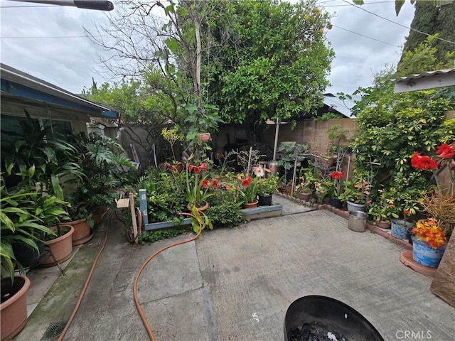 view of patio with fence and a fire pit