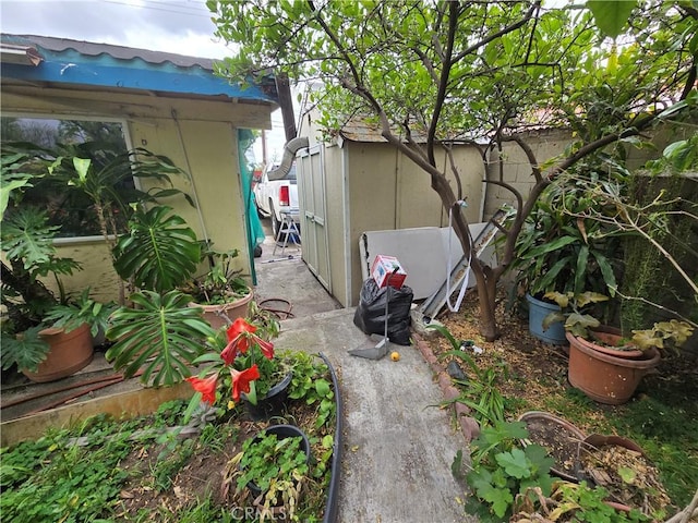 view of property exterior with an outdoor structure and a shed