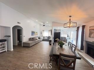 14000 Fenton Ave, Sylmar, CA 91342 - dining area featuring a fireplace, arched walkways, a chandelier, recessed lighting, and wood finished floors