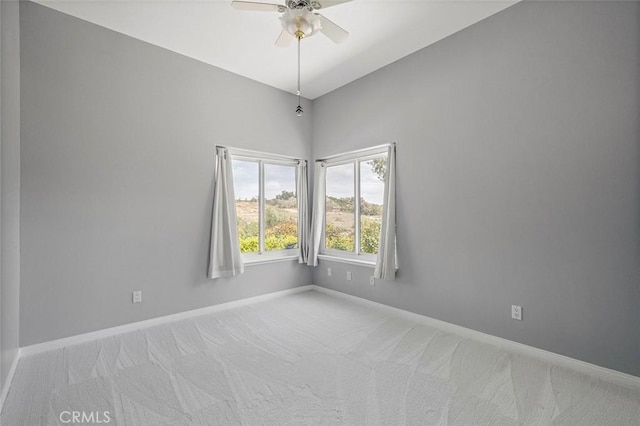 unfurnished room featuring carpet floors, baseboards, and ceiling fan