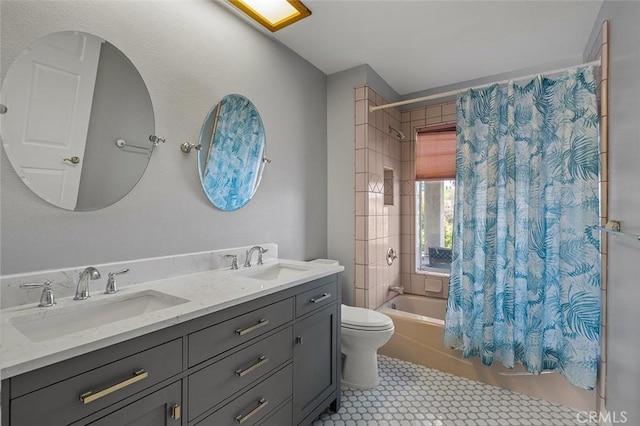 full bath with a sink, shower / bathtub combination with curtain, double vanity, and toilet