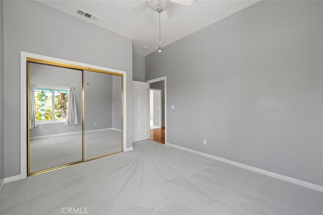 unfurnished bedroom featuring baseboards, carpet floors, visible vents, and a closet