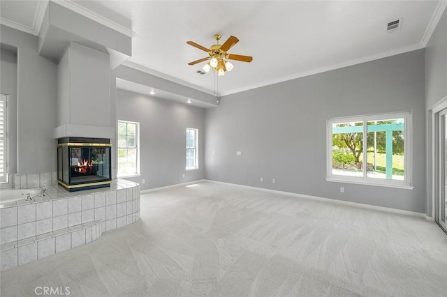 unfurnished living room with visible vents, crown molding, and light colored carpet