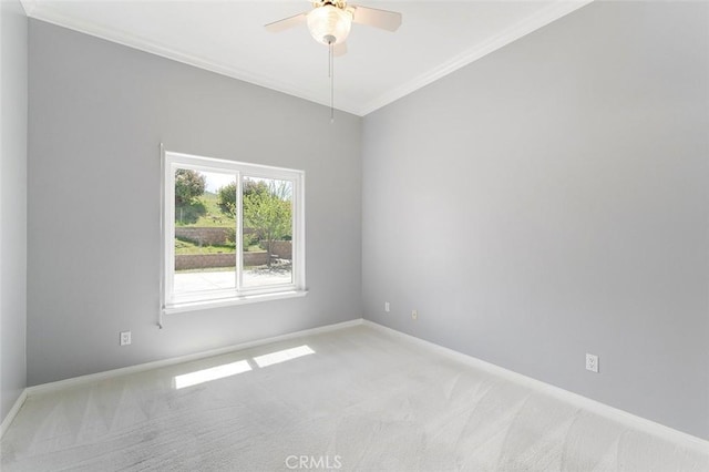 unfurnished room featuring baseboards, a ceiling fan, carpet flooring, and ornamental molding