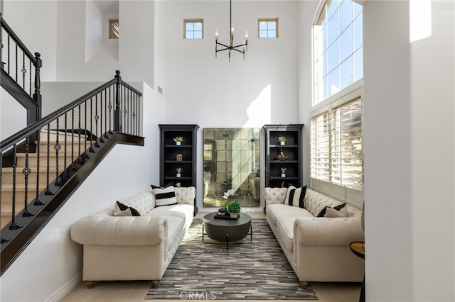29311 Paseo Palmar, San Juan Capistrano, CA 92675 - living area with wood finished floors, a towering ceiling, a chandelier, and stairway