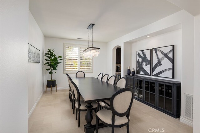 29311 Paseo Palmar, San Juan Capistrano, CA 92675 - dining room featuring arched walkways, baseboards, a chandelier, and light flooring