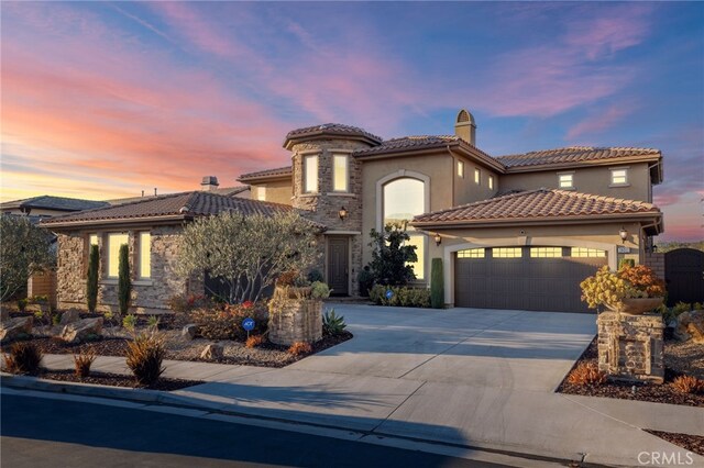29311 Paseo Palmar, San Juan Capistrano, CA 92675 - mediterranean / spanish home featuring stone siding, an attached garage, stucco siding, concrete driveway, and a tile roof