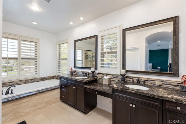 29311 Paseo Palmar, San Juan Capistrano, CA 92675 - full bathroom featuring plenty of natural light, double vanity, a garden tub, backsplash, and recessed lighting