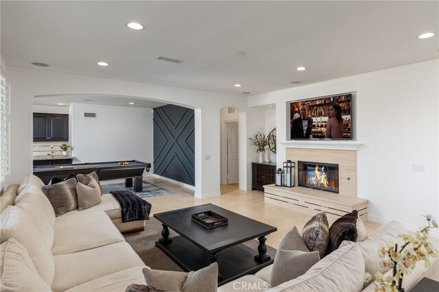 29311 Paseo Palmar, San Juan Capistrano, CA 92675 - living area featuring arched walkways, billiards table, a glass covered fireplace, recessed lighting, and baseboards