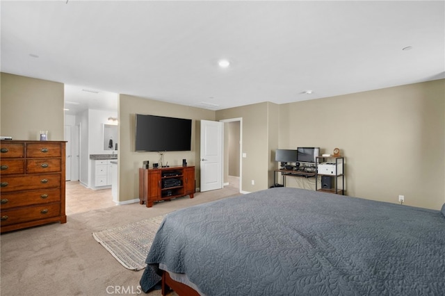 bedroom featuring light carpet, baseboards, and connected bathroom