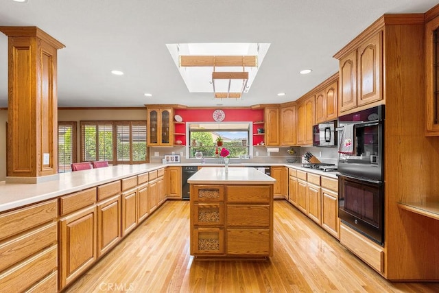 130 N Avenida Veracruz, Anaheim, CA 92808 - kitchen with open shelves, light wood-style floors, plenty of natural light, a skylight, and black appliances