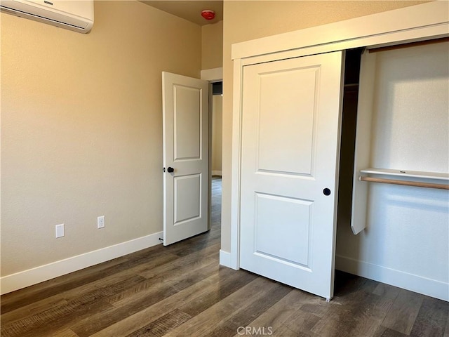 1411 Elliott Rd, Paradise, CA 95969 - unfurnished bedroom with a wall mounted AC, dark wood-type flooring, and a closet