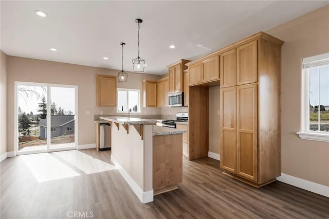 1411 Elliott Rd, Paradise, CA 95969 - kitchen with stainless steel appliances, wood finished floors, plenty of natural light, a center island, and recessed lighting