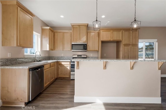 1411 Elliott Rd, Paradise, CA 95969 - kitchen featuring stainless steel appliances, light brown cabinets, dark wood-style flooring, a kitchen breakfast bar, and recessed lighting