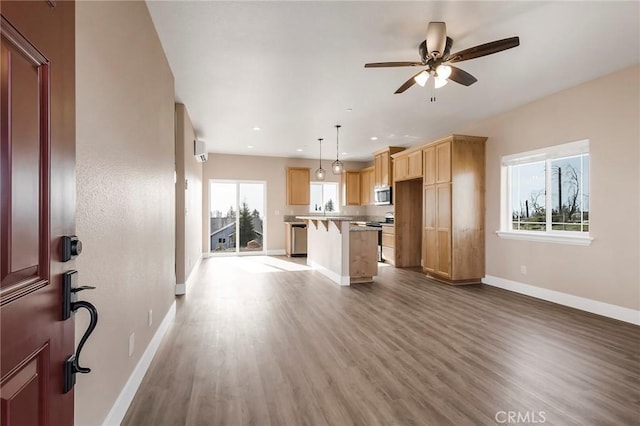 1411 Elliott Rd, Paradise, CA 95969 - kitchen featuring a kitchen breakfast bar, wood finished floors, ceiling fan, a center island, and recessed lighting