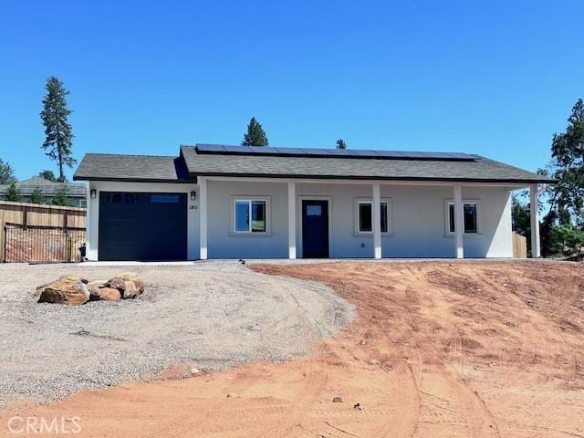 1411 Elliott Rd, Paradise, CA 95969 - ranch-style house featuring a garage, roof mounted solar panels, and stucco siding