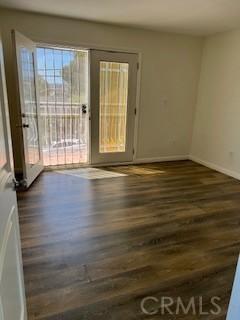 586 W 1st St, San Pedro, CA 90731 - spare room featuring dark wood finished floors and baseboards