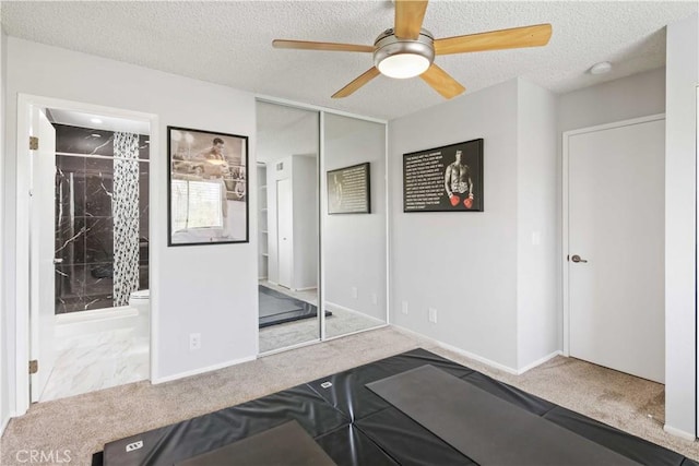 27633 Nugget Dr Unit 1, Canyon Country, CA 91387 - exercise area with baseboards, a ceiling fan, a textured ceiling, and carpet