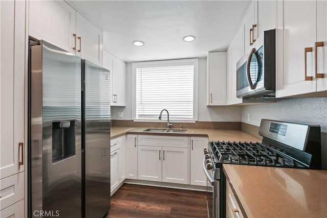 27633 Nugget Dr Unit 1, Canyon Country, CA 91387 - kitchen with a sink, white cabinets, appliances with stainless steel finishes, dark wood-type flooring, and recessed lighting