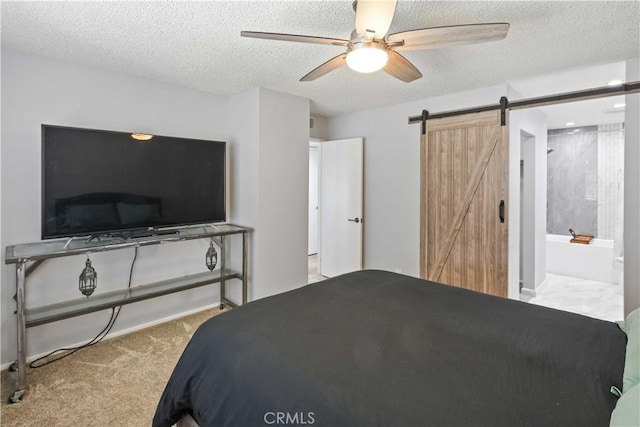 27633 Nugget Dr Unit 1, Canyon Country, CA 91387 - bedroom with a barn door, carpet, a textured ceiling, ceiling fan, and ensuite bathroom