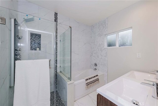 bathroom with a garden tub, a sink, double vanity, and a stall shower