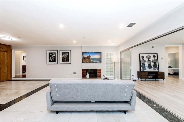 living room with visible vents, a brick fireplace, recessed lighting, and crown molding