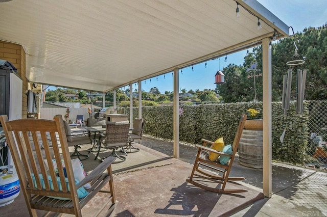 view of patio featuring outdoor dining area and a fenced backyard