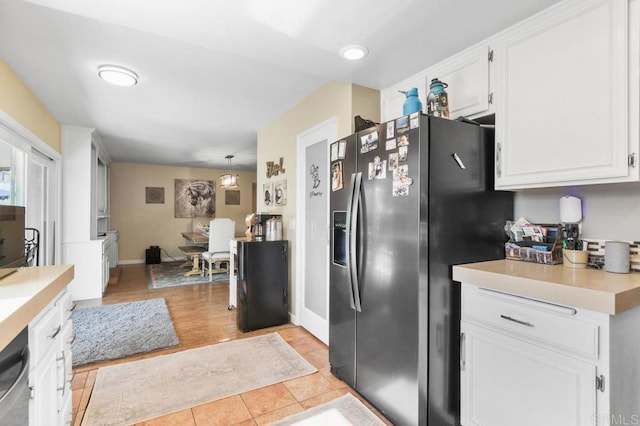 kitchen with white cabinets, light countertops, stainless steel appliances, baseboards, and light tile patterned floors