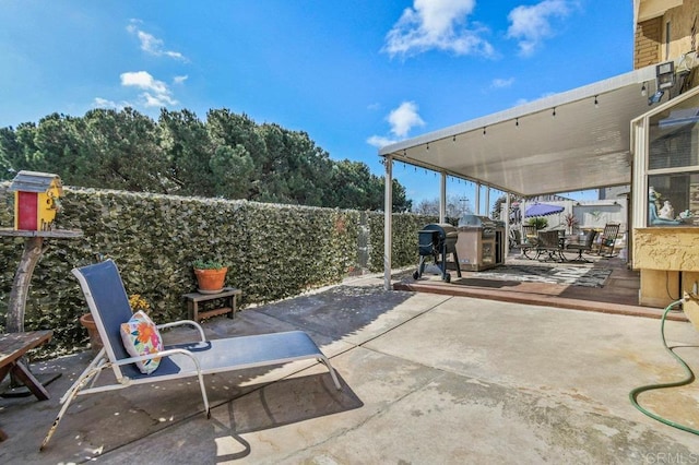 view of patio / terrace featuring grilling area, a fenced backyard, and outdoor dining space