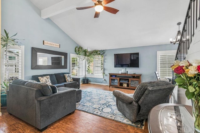 living area featuring ceiling fan, lofted ceiling with beams, and wood finished floors