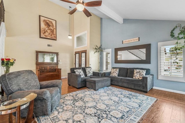 living area with beam ceiling, high vaulted ceiling, a ceiling fan, baseboards, and wood finished floors