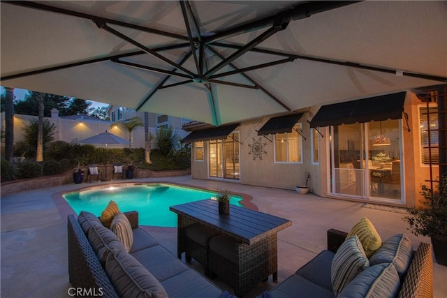 outdoor pool with an outdoor living space and a patio area