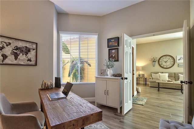 office featuring baseboards and wood finished floors