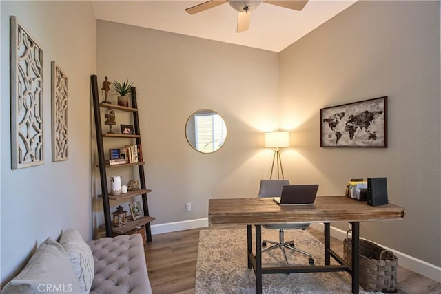 office space with a ceiling fan, wood finished floors, and baseboards