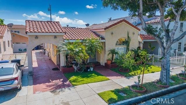 6114 Allston St, Los Angeles, CA 90022 - mediterranean / spanish home featuring stucco siding, concrete driveway, a tiled roof, and fence