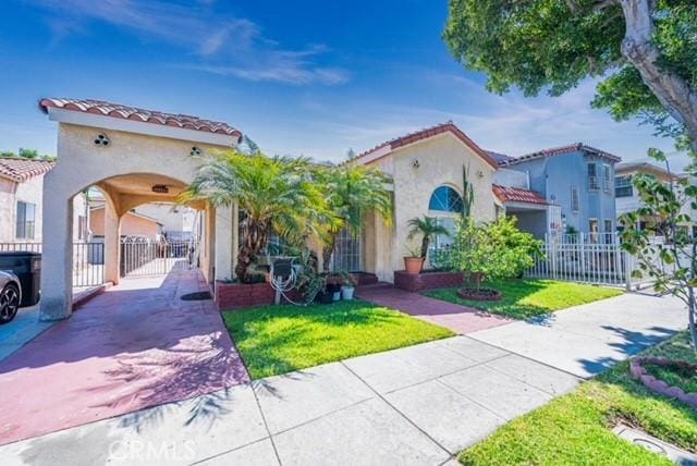 6114 Allston St, Los Angeles, CA 90022 - mediterranean / spanish-style house with a tiled roof, a gate, fence, a front yard, and stucco siding