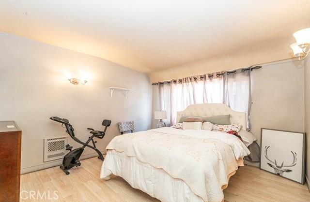 6114 Allston St, Los Angeles, CA 90022 - bedroom featuring lofted ceiling, visible vents, and light wood finished floors