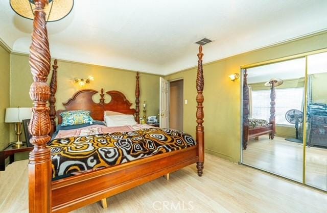 6114 Allston St, Los Angeles, CA 90022 - bedroom featuring access to outside, wood finished floors, and visible vents