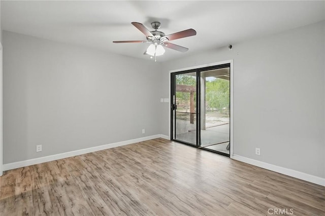 unfurnished room featuring wood finished floors, baseboards, and ceiling fan