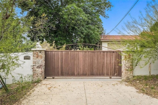 view of gate with fence