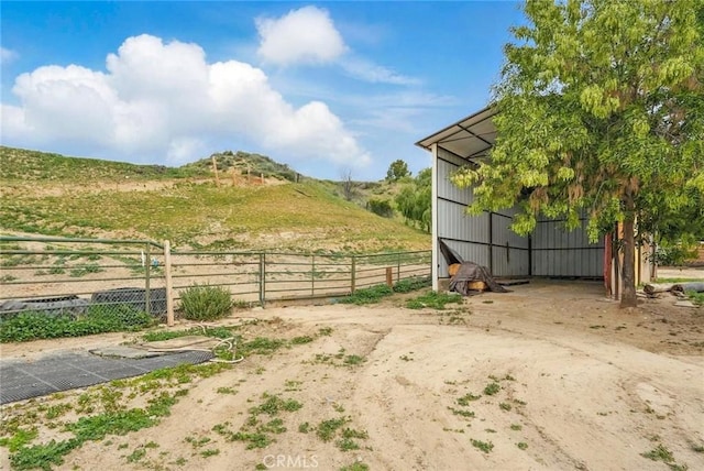view of yard with an outdoor structure, an outbuilding, and fence