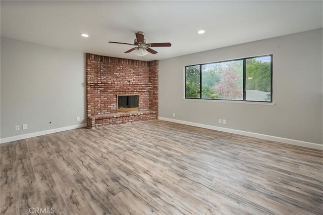 unfurnished living room with recessed lighting, wood finished floors, baseboards, and ceiling fan