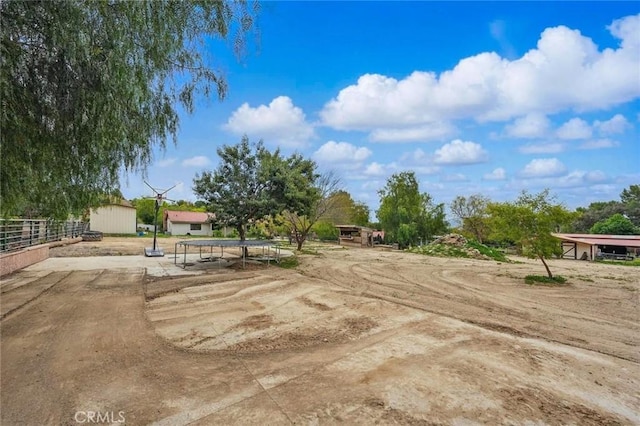 view of yard with an outbuilding and fence